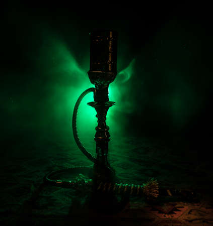 Shisha Concept. Hookah hot coals on shisha bowl with black background. Stylish oriental shisha with colorful lights. Selective focusの写真素材