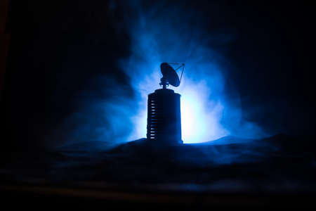 Silhouettes of satellite dishes or radio antennas against night sky. Space observatory or Air...