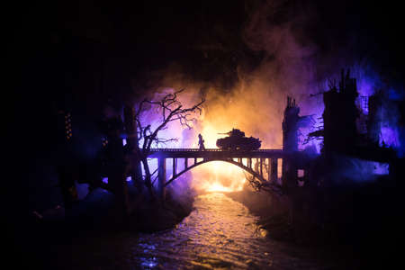 War Concept. Military silhouettes fighting scene on war fog sky background, World War Soldiers Silhouette Below Cloudy Skyline At night. Battle in ruined city. Selective focusの写真素材