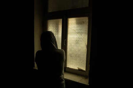 Horror silhouette inside abandoned creepy room with window at night. horror scene. Halloween concept.の写真素材