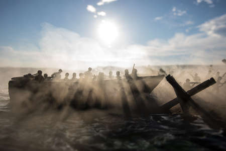 World War 2 reenactment (D-day). Creative decoration with toy soldiers, landing crafts and hedgehogs. Battle scene of Normandy landing on June 6, 1944. Selective focusの写真素材