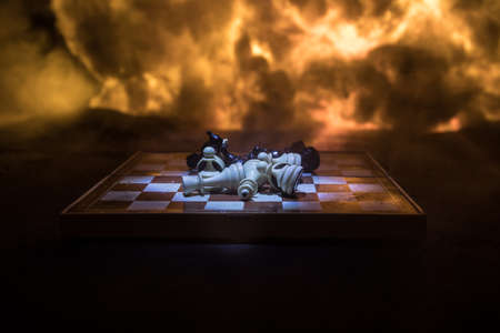 Chess board game concept of business ideas and competition or war theme. Chess figures on a dark...
