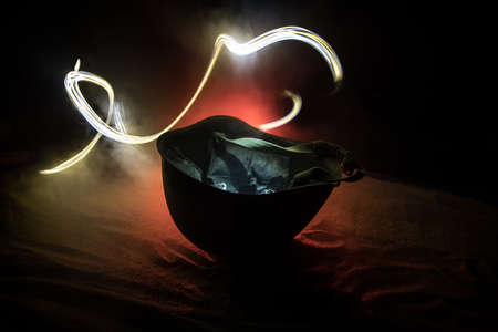 Soviet army Helmet Second World War on sand with backlight and smoke. war concept. selective focusの写真素材