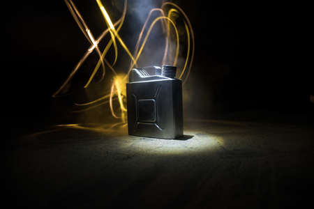 Metallic fuel container. Canister for gasoline, diesel gas.Fire resistant storage tank on dark with backlight. selective focusの写真素材