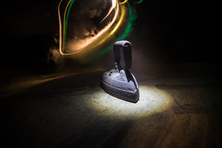 Old vintage flat iron on dark background, Antique iron ,retro iron. selective focus