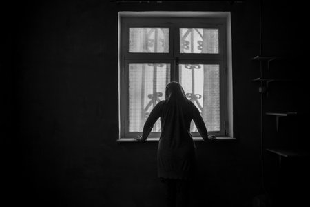 Horror silhouette inside abandoned creepy room with window at night. horror scene. Halloween concept.の写真素材