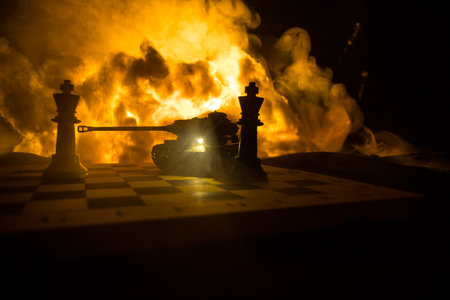 War between Russia and Ukraine, conceptual image of war using chess board and tank on a dark background of explosion. Ukrainian and Russian crisis, political conflict. selective focusの写真素材