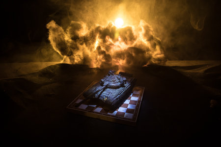 War between Russia and Ukraine, conceptual image of war using chess board and tank on a dark background of explosion. Ukrainian and Russian crisis, political conflict. selective focusの写真素材