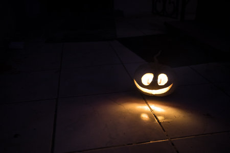 Halloween horror concept with glowing pumpkin. Halloween evil pumkins smilin faces in dark. selective focus. long exposure shotの写真素材