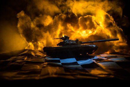 War between Russia and Ukraine, conceptual image of war using chess board and tank on a dark background of explosion. Ukrainian and Russian crisis, political conflict. selective focusの写真素材