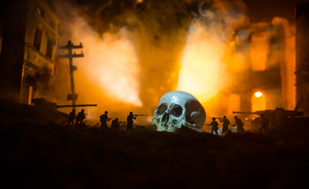 Concept of death soldiers during the war. Giant human skull with military fighting silhouettes in...
