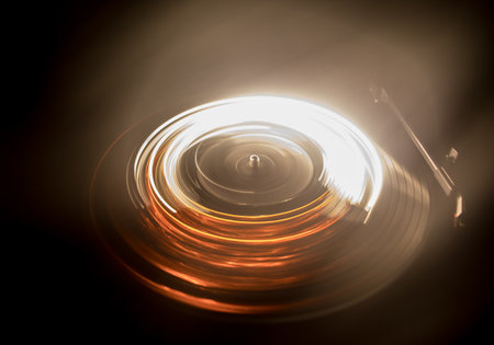 Music DJ concept. Trail of fire and smoke on vinyl record. Burning vinyl disk. Turntable vinyl record player on dark background. selective focusの写真素材