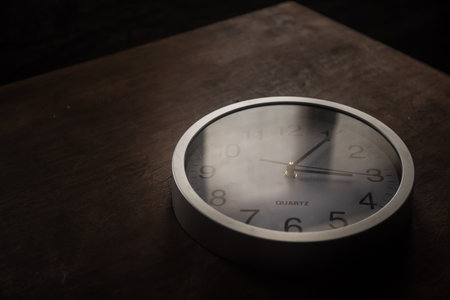 time concept. Old rustic wall clock on old wooden table with copy space studio shot