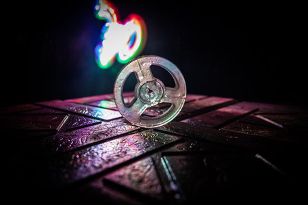 Plastic empty bobbin on dark toned background with light. music concept. selective focusの写真素材