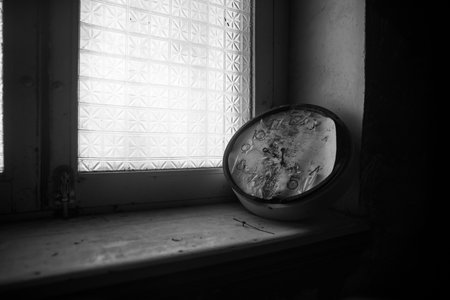 Old and vintage blank clock dial without hand on old wooden windowsill. studio shotの写真素材