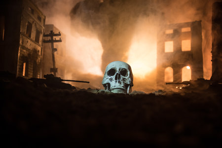 Concept of death soldiers during the war. Giant human skull with military fighting silhouettes in destroyed city. selective focusの写真素材