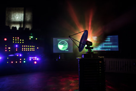 creative art decoration. military concept. Air defense hardware workplace vintage style. Satellite dishes or radio antennas against control equipment. low key. selective focus.の写真素材