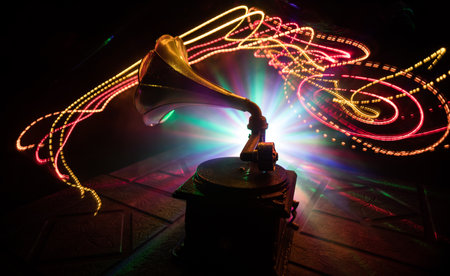music concept. Old gramophone on a dark background. Retro gramophone with disc on wooden table with toned backlight. selective focusの写真素材