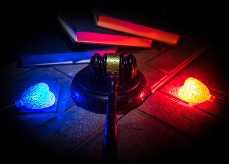 Law theme, mallet of the judge on wooden desk. Law gavel on dark foggy background with light. selective focusの写真素材
