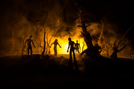 Scary view of zombies at cemetery dead tree, moon, church and spooky cloudy sky with fog, Horror Halloween concept. selective focusの写真素材