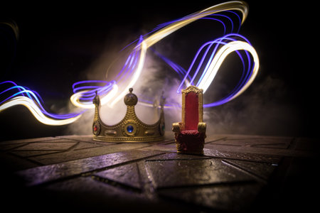 Red royal chair miniature on wooden table. Place for the king. Medieval Throne. selective focusの写真素材