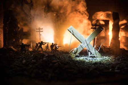 Concept of war or manipulation with global politics. The puppeteer controls soldiers. Night battle scene. Military fighting silhouettes in destroyed city. Selective focusの写真素材