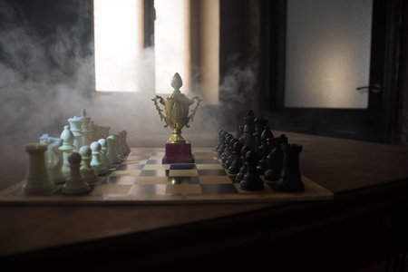 Chess board game concept of business ideas, competition and strategy. Chess figures on a dark background with smoke and fog. selective focusの写真素材