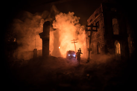 Silhouette soldier carrying little boy on his shoulder from fire. Rescue savior concept. Man moving out with little boy from burned out city destroyed in war. selective focusの写真素材