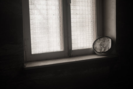 Old and vintage blank clock dial without hand on old wooden windowsill. studio shotの写真素材