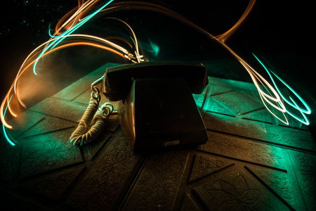 old telephone without numbers on old wood plank with art dark background with fog and toned light. empty space. selective focusの写真素材