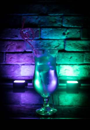 colorful cocktail in glass on dark background or Glasses of cocktails on bar background.Party club entertainment. mixed lightの写真素材