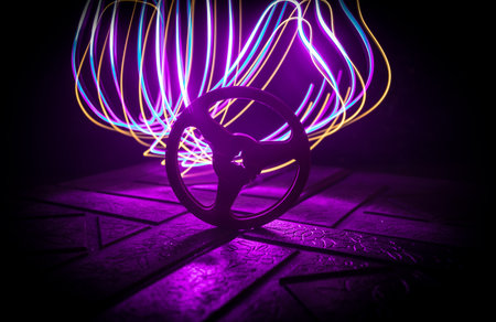 Plastic empty bobbin on dark toned background with light. music concept. selective focusの写真素材