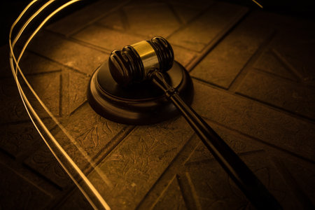 Law theme, mallet of the judge on wooden desk. Law gavel on dark foggy background with light. selective focusの写真素材