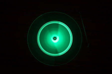 Music DJ concept. Trail of fire and smoke on vinyl record. Burning vinyl disk. Turntable vinyl record player on dark background. selective focusの写真素材