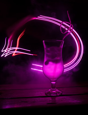 colorful cocktail in glass on dark background or Glasses of cocktails on bar background.Party club entertainment. mixed lightの写真素材