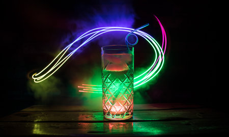 colorful cocktail in glass on dark background or Glasses of cocktails on bar background.Party club entertainment. mixed lightの写真素材
