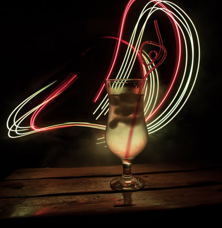colorful cocktail in glass on dark background or Glasses of cocktails on bar background.Party club entertainment. mixed lightの写真素材