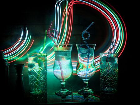 colorful cocktail in glass on dark background or Glasses of cocktails on bar background.Party club entertainment. mixed lightの写真素材
