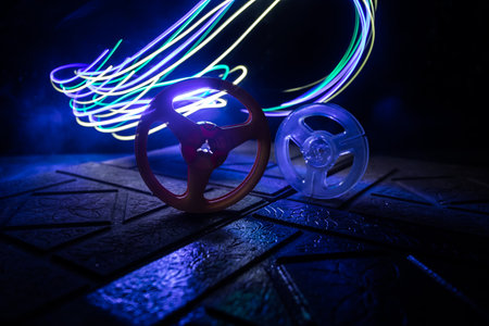 Plastic empty bobbin on dark toned background with light. music concept. selective focusの写真素材