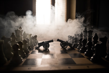 Medieval battle scene with two cannons on chessboard. Chess board game concept of business ideas and...