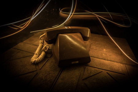 old telephone without numbers on old wood plank with art dark background with fog and toned light. empty space. selective focusの写真素材