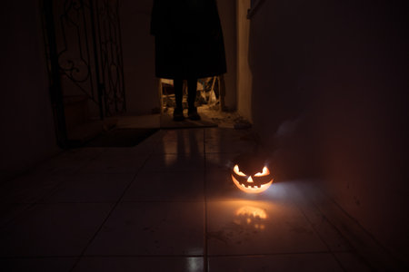 Halloween horror concept with glowing pumpkin. Halloween evil pumkins smilin faces in dark. selective focus. long exposure shotの写真素材
