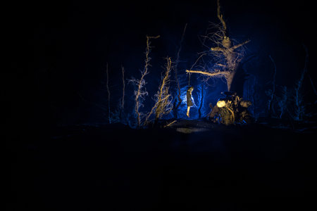 Horror view of hung girl on tree at night Suicide decoration. Death punishment executions or suicide abstract idea.の写真素材