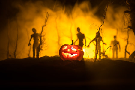 Scary view of zombies at cemetery dead tree, moon, church and spooky cloudy sky with fog, Horror Halloween concept. selective focusの写真素材