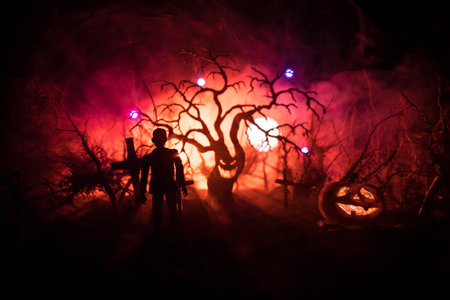 Scary view of zombies at cemetery dead tree, moon, church and spooky cloudy sky with fog, Horror Halloween concept. selective focusの写真素材