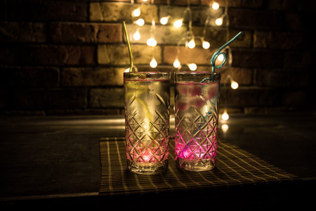 colorful cocktail in glass on dark background or Glasses of cocktails on bar background.Party club entertainment. mixed lightの写真素材