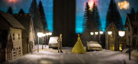 Little decorative cute small houses in snow at night in winter, Christmas and New Year miniature house in the snow at night with fir tree. Holiday concept. Selective focusの写真素材