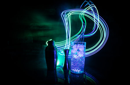 colorful cocktail in glass on dark background or Glasses of cocktails on bar background.Party club entertainment. mixed lightの写真素材