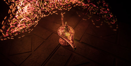 Antique Aladdin arabian nights genie style oil lamp with soft light white smoke, Dark background. Lamp of wishes conceptの写真素材