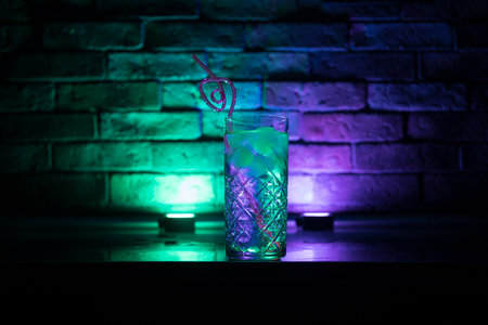 colorful cocktail in glass on dark background or Glasses of cocktails on bar background.Party club entertainment. mixed lightの写真素材